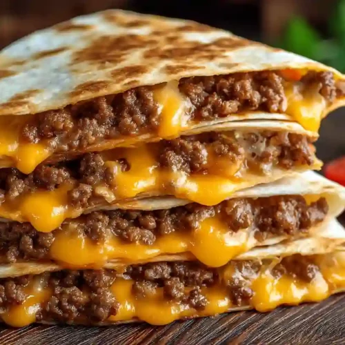 Smashburger Quesadillas - A Cozy, Crispy Family Dinner Favorite 3 Close-up of stacked smashburger quesadillas with melted cheddar and ground beef
